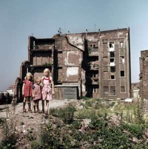 Filles sur un tas de débris devant les ruine d'une maison d'habitation, Cologne, 1956